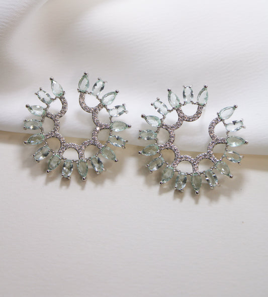 Circular earing in green and clear zirc.