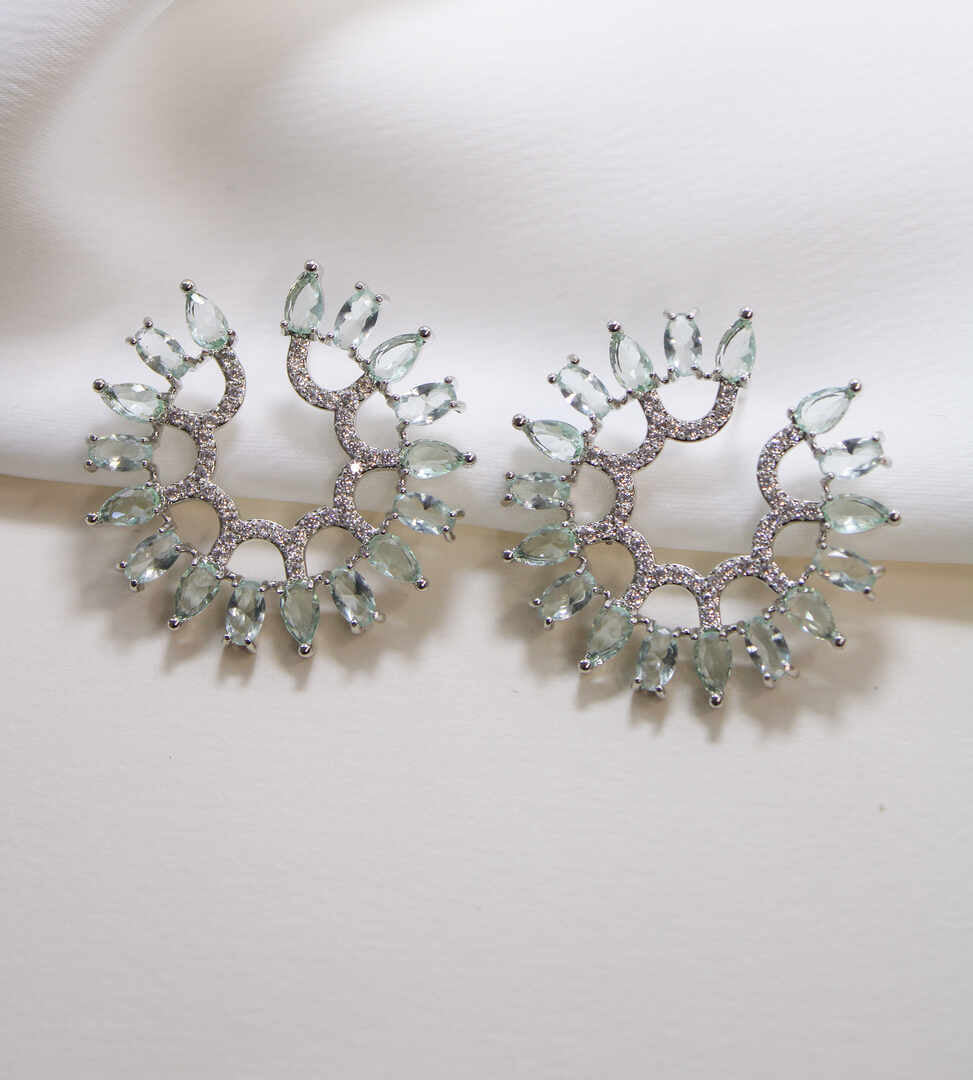 Circular earing in green and clear zirc.