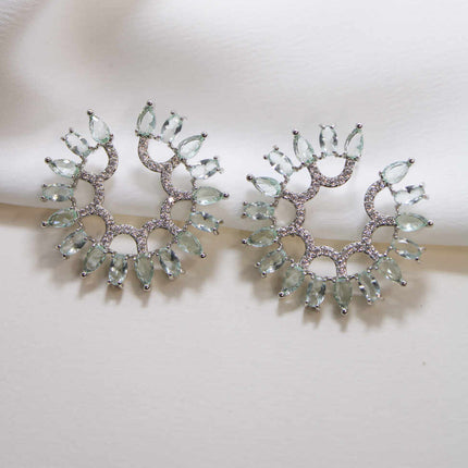 Circular earing in green and clear zirc.